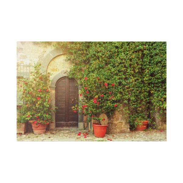 Stone building with wooden door and flowers.