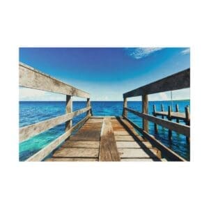 Wooden pier leading to turquoise ocean.