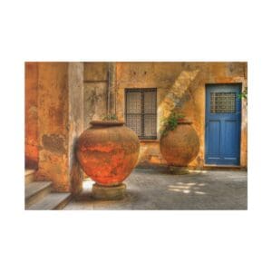 Two terracotta pots outside a blue door.