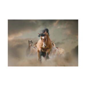 Horses running through dusty landscape at sunset.