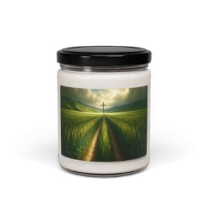 Candle jar with cross and field design.