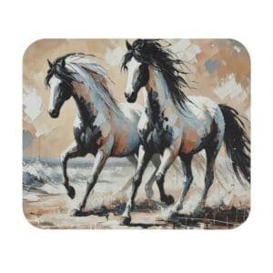 Two horses running on a beach.